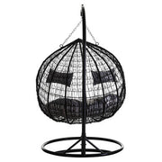 Angled view of the black rattan double hanging chair, plain background