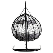 Angled view of the black rattan double hanging chair, plain background