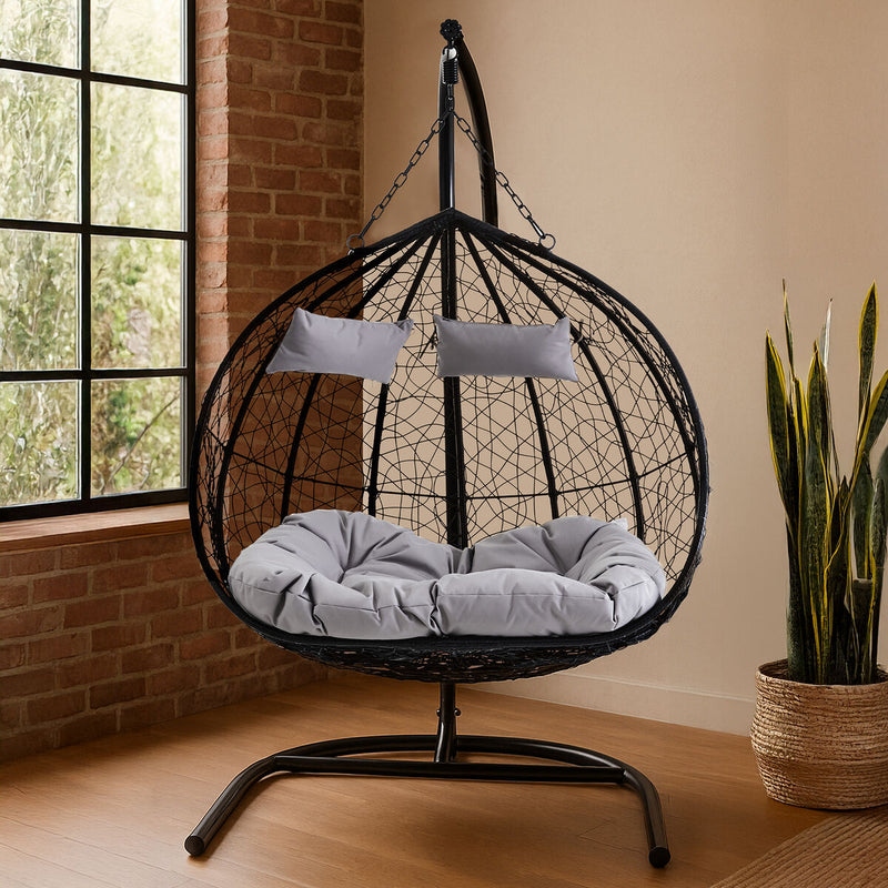 Black rattan double hanging chair styled in a lounge setting