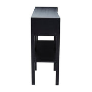Black rattan console table with one drawer open to show the storage space