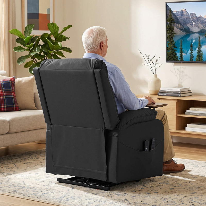Rear view of a man sitting in the black recliner in a living room