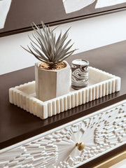 Room setting showing the black and gold console table against a plain wall