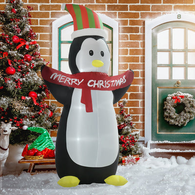 Inflatable penguin by a front door with a Christmas tree and wreath