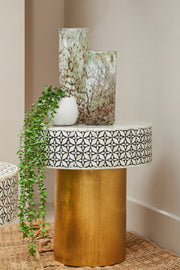 Living room scene featuring the black and gold round bone inlay side table
