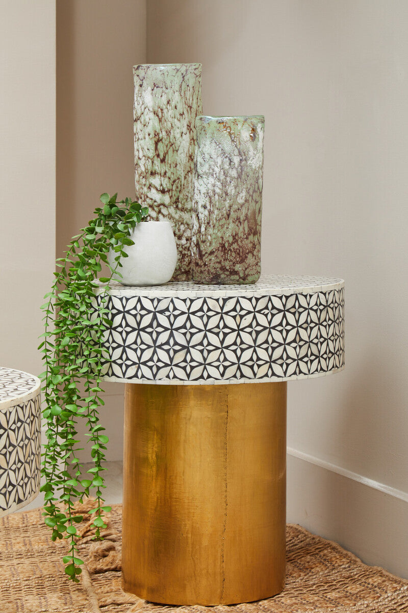 Living room scene featuring the black and gold round bone inlay side table