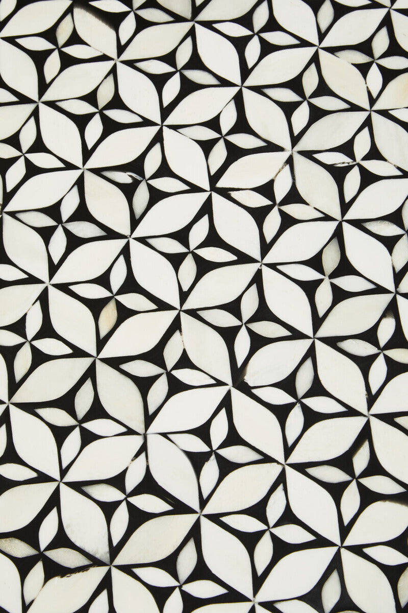 Macro detail of the gold base foot of the bone inlay side table
