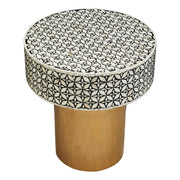 Overhead view of the symmetrical white bone inlay floral motif on the black round top