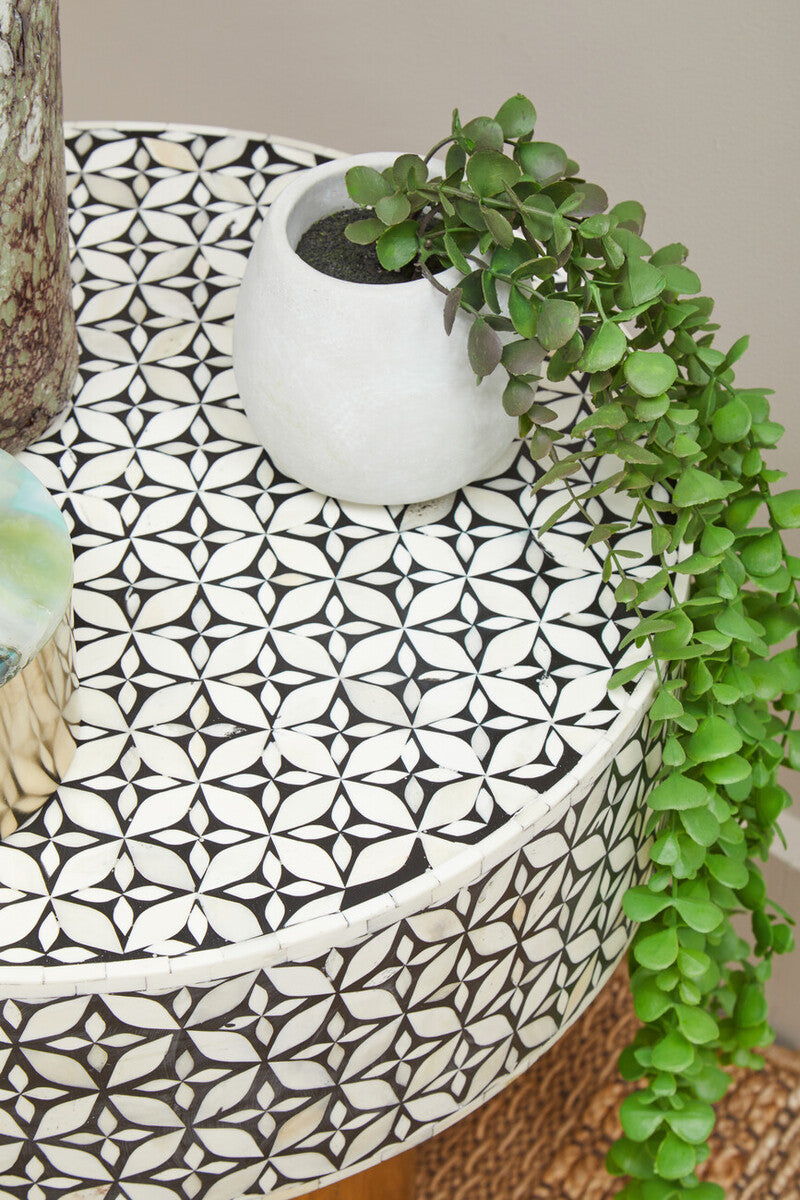Bone inlay side table styled beside a lounge chair with a table lamp