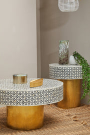 Bone inlay round side table used as a bedside table in a guest bedroom