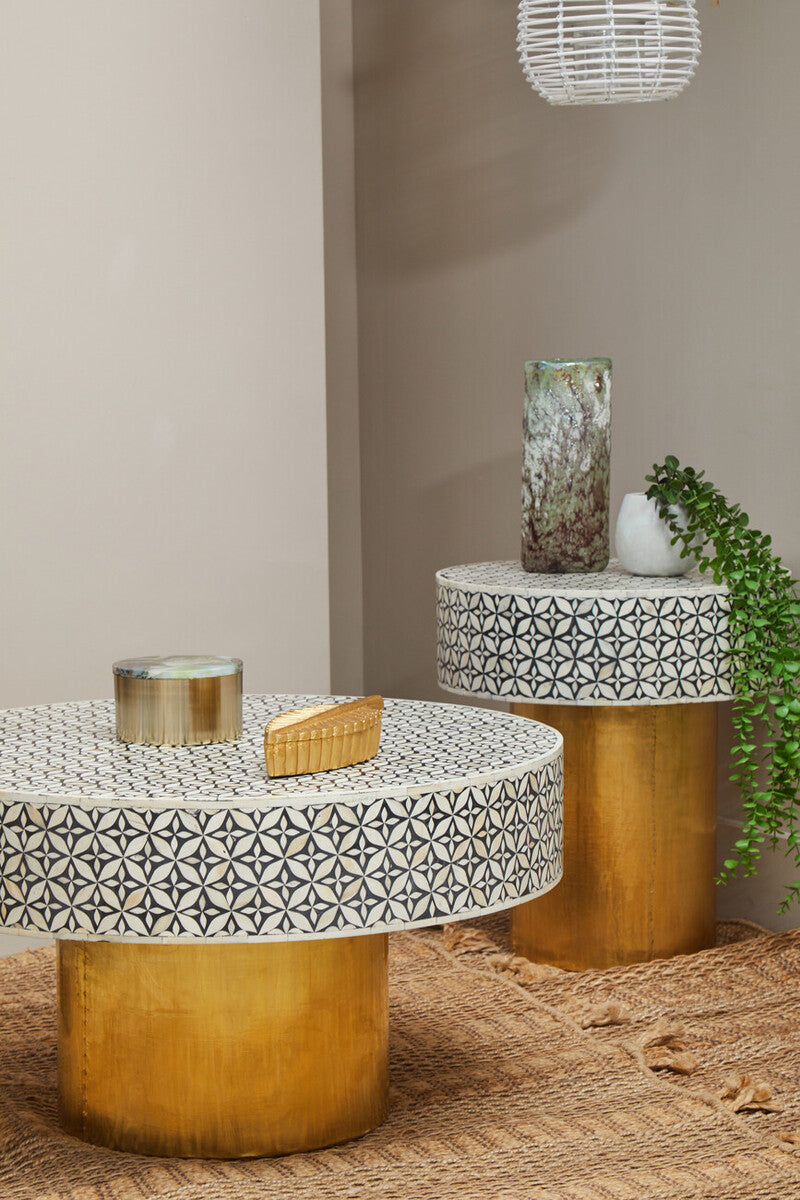 Bone inlay round side table used as a bedside table in a guest bedroom