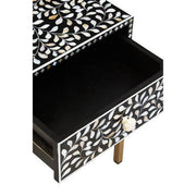 Close-up of the carved white floral drawer knob