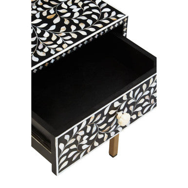 Close-up of the carved white floral drawer knob