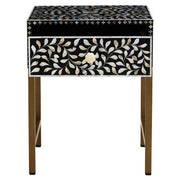 Front view of the black side table with white floral bone inlay drawer front