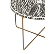 Close-up of the gold leg foot and its join to the black inlaid tabletop