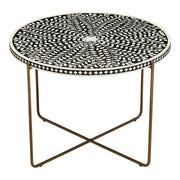 Overhead view of the white bone inlay leaf-and-vine motif on the black round table top