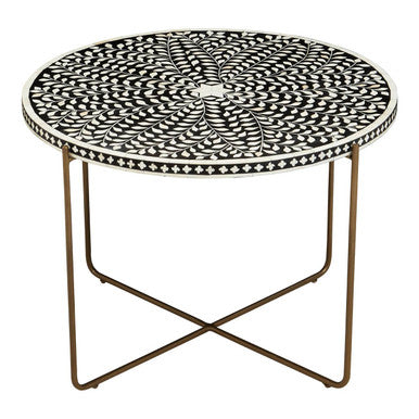 Overhead view of the white bone inlay leaf-and-vine motif on the black round table top