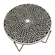 Side view of the slim gold iron legs and cross stretcher beneath the inlaid top