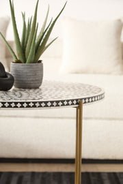 Bone inlay coffee table centred between two club chairs on a neutral rug