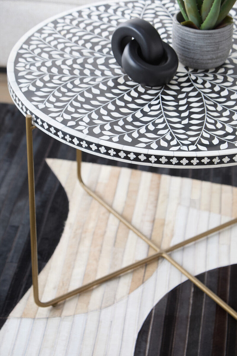 Living room scene with the round bone inlay coffee table beside a sectional sofa