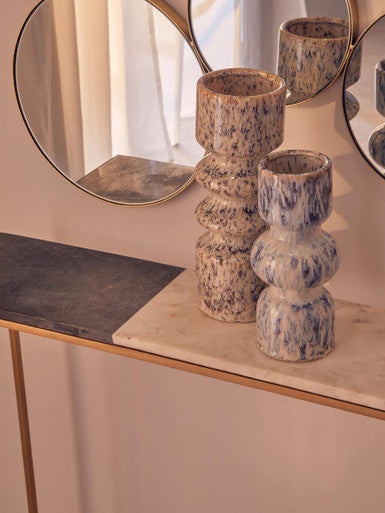 Marble console table styled in situ with a mirror above and lamps either side
