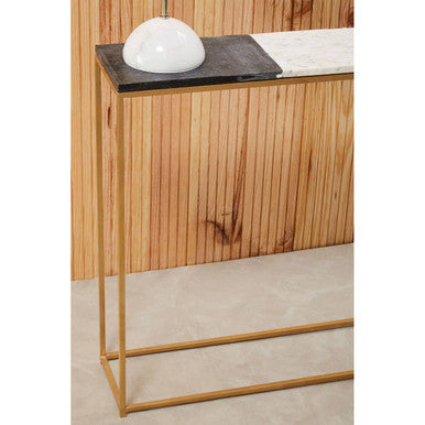 Marble console table styled with books and candles in a modern living space