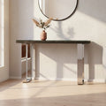 Black wood and clear glass console table with silver U-shaped legs styled in a modern hallway
