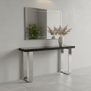 Silver U-leg console table dressed with a lamp and mirror in a living room setting