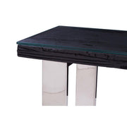 Detail of the join between the silver metal frame and the glass tabletop edge