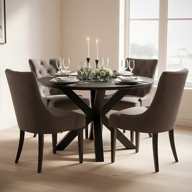 Black wood veneer round dining table set for a meal in a modern dining room