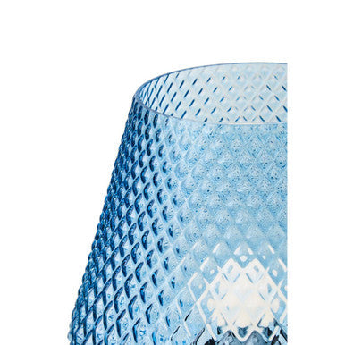 Close-up of embossed texture on blue glass lamp body