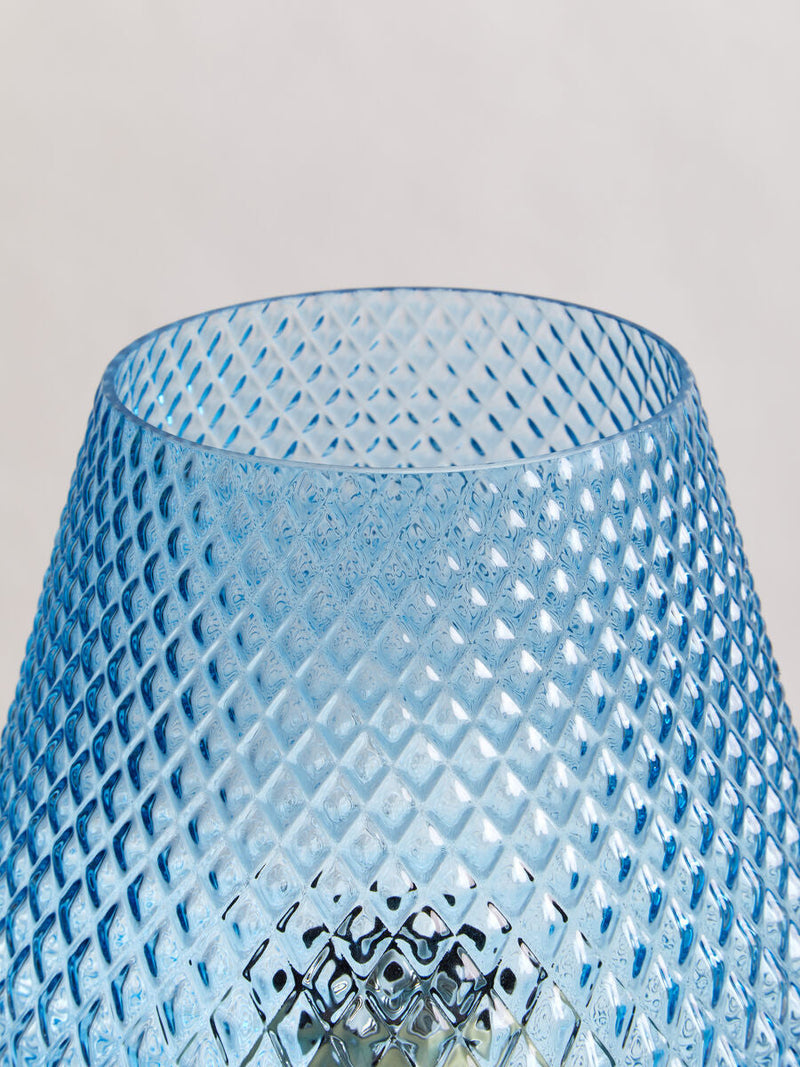 Blue glass table lamp styled on a console