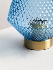 Blue glass table lamp in a room setting