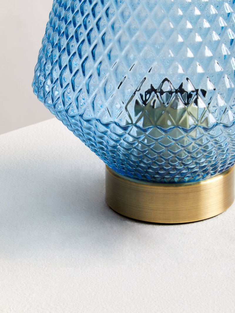 Blue glass table lamp in a room setting