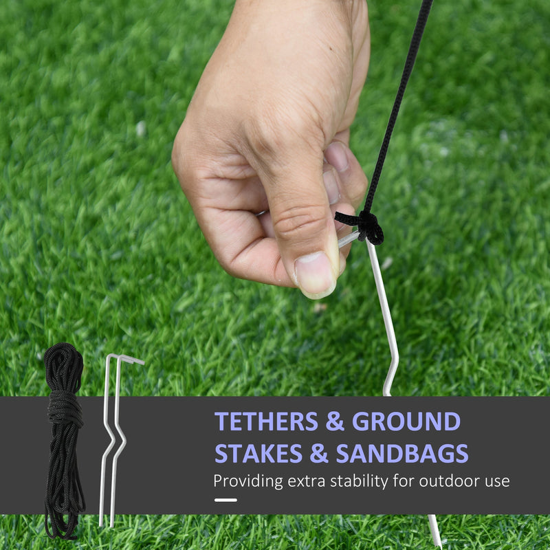 Hand tying a tether rope to a ground stake with tethers, stakes and sandbags label
