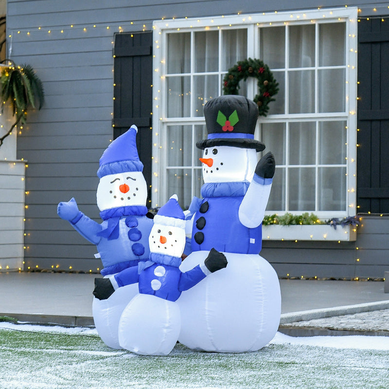 Inflatable snowman family outside a house with a window and wreath