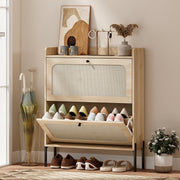 Oak rattan shoe cabinet in a hallway entryway with shoes stored in the open lower drawer