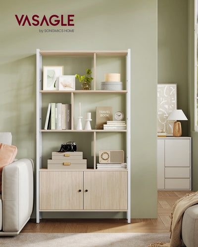 Beige and white bookcase styled in a living room with books, decor and plants on the open shelves