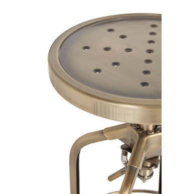 Close-up of brass finish steel frame on adjustable bar stool