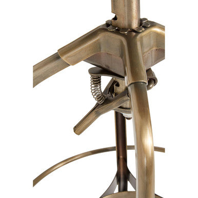 Close-up of brass bar stool seat and height adjustment mechanism