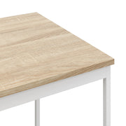 Close-up of the oak wood-effect tabletop corner and white metal leg