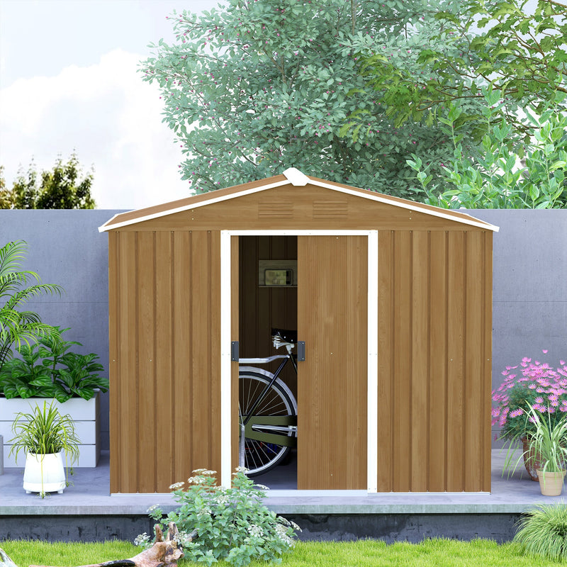 Front view of the brown shed on a paved base with one sliding door part open