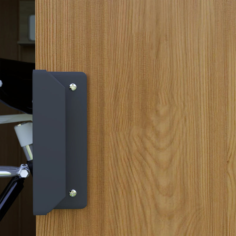 Close-up of the black door handle screwed to the brown wood effect sliding door