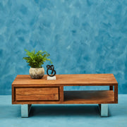 Brown acacia wood coffee table styled in a living room