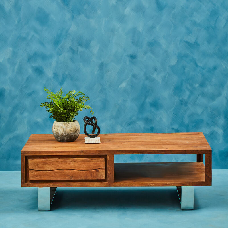 Brown acacia wood coffee table styled in a living room
