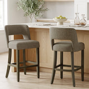 Two brown bar stools at a wooden kitchen island with a fruit bowl