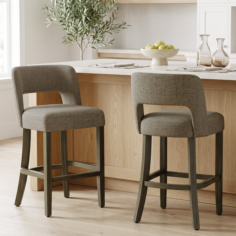 Two brown bar stools at a wooden kitchen island with a fruit bowl