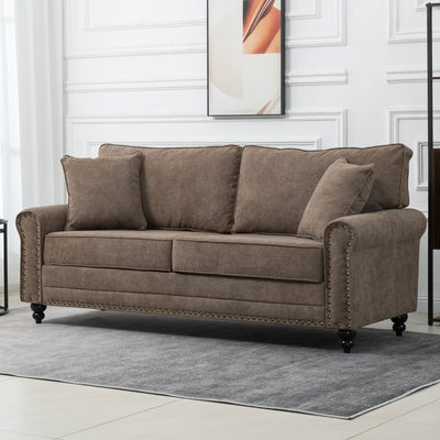 Brown fabric sofa styled in a living room with wall art and throw