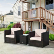 Brown rattan bistro set with two armchairs and side table on a patio below a balcony