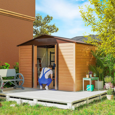 Wood effect shed on a garden deck with sliding doors open and a person kneeling inside