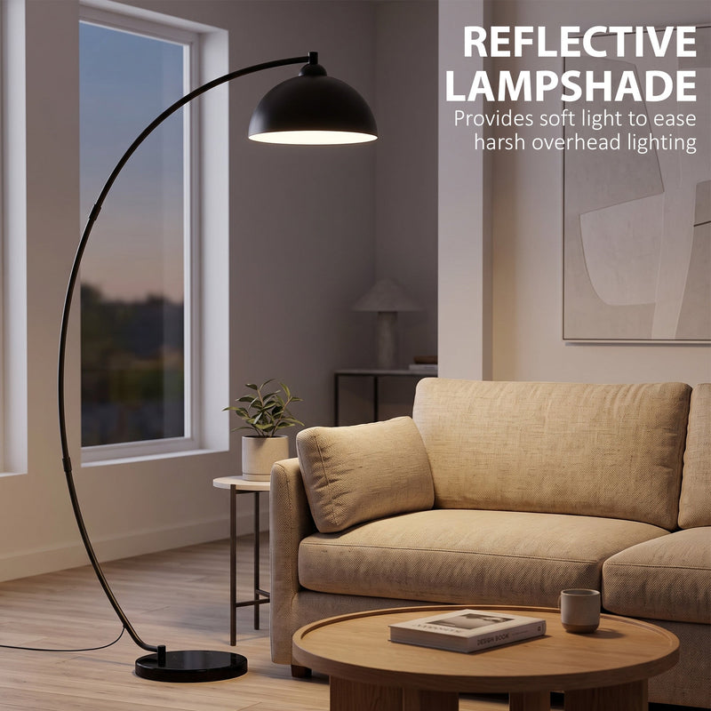 Arc lamp arching over an armchair with text about its reflective lampshade